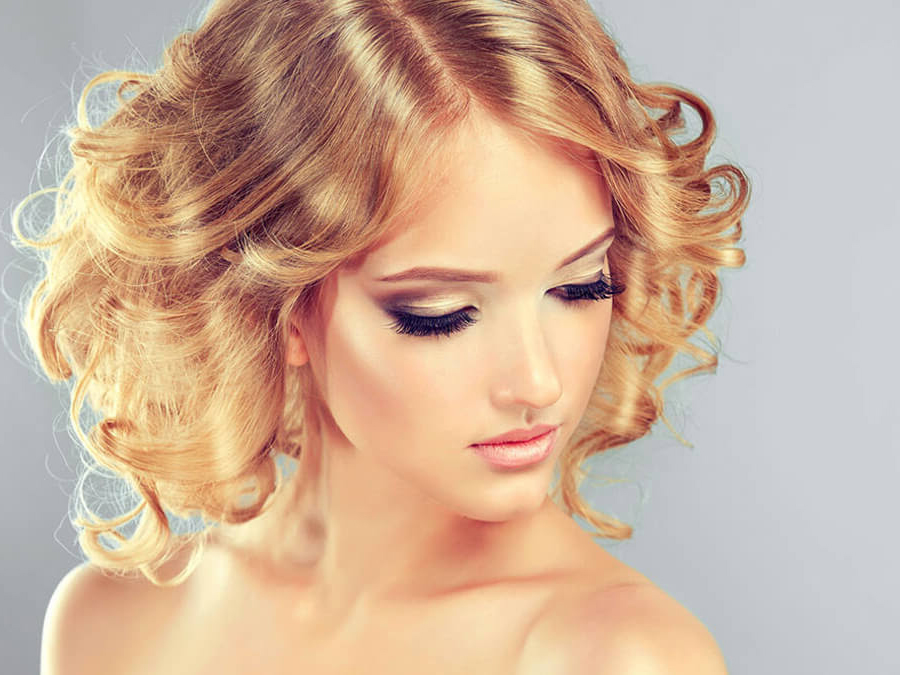 Girl with blonde hair and signature lashes.